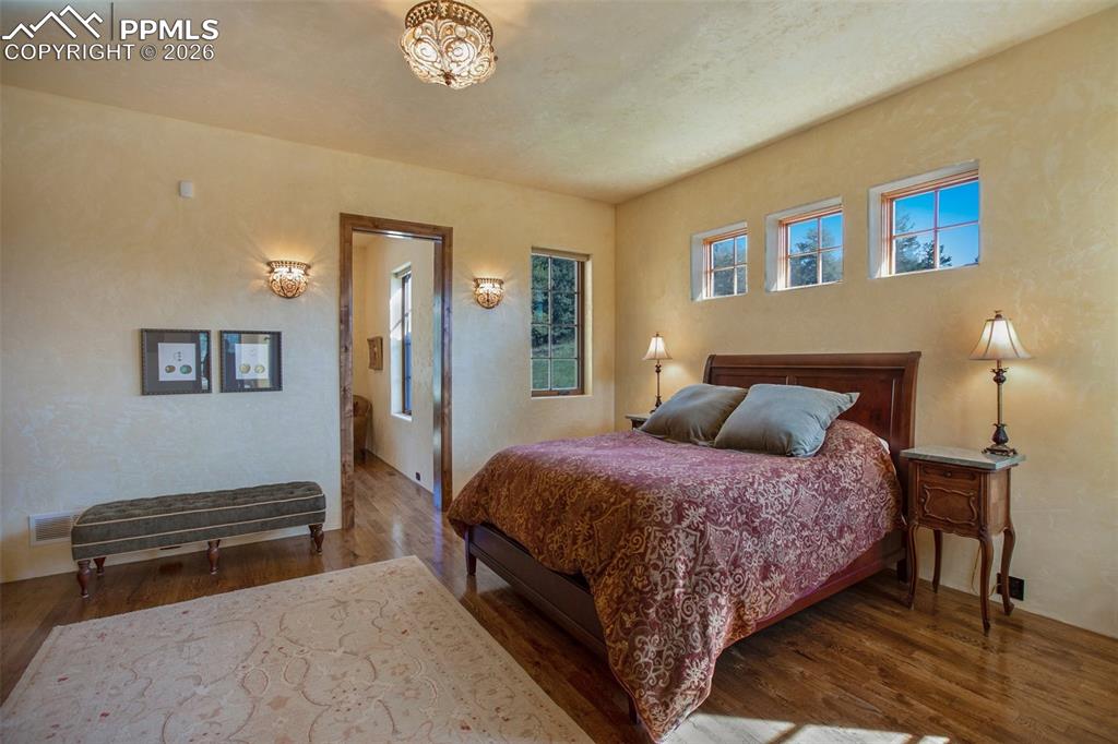 Image 22 of 50: Primary/Master suite with hardwood floors, and entrance to the adjacent off