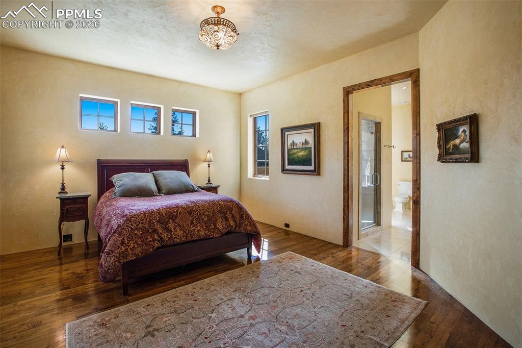 Image 23 of 50: Primary/Master suite with ensuite 5-piece bath featuring stone floors and c