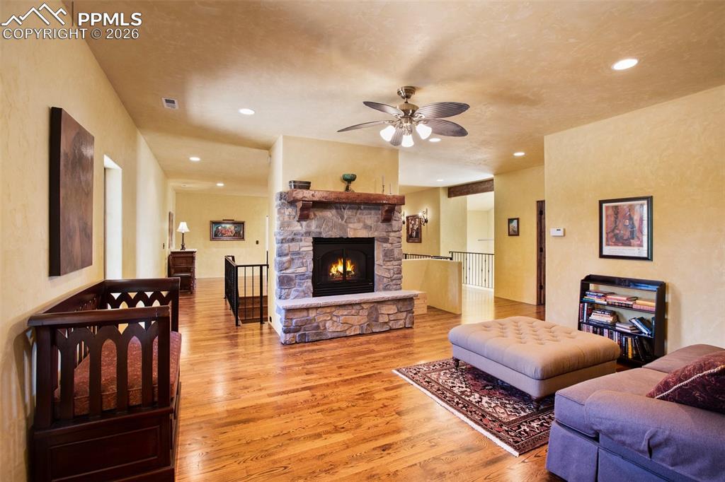 Image 28 of 50: A private family space on the upper level with stone gas fireplace w/ blowe