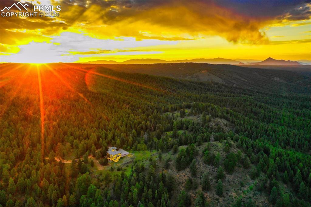 Image 3 of 50: Beautiful aerial over the property and home boardered on 2 sides by nationa
