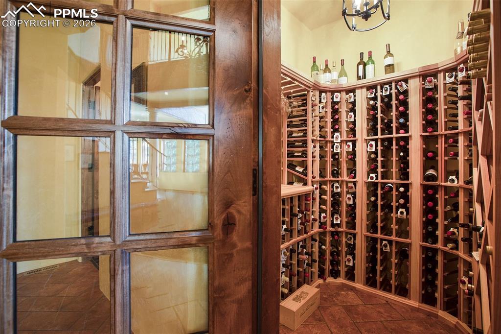 Image 8 of 50: Natural temperature controlled, unheated wine cellar with tile floors.