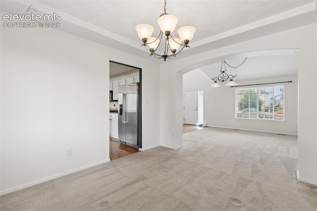 Image 11 of 47: Formal Dining Space Open to the Living Room