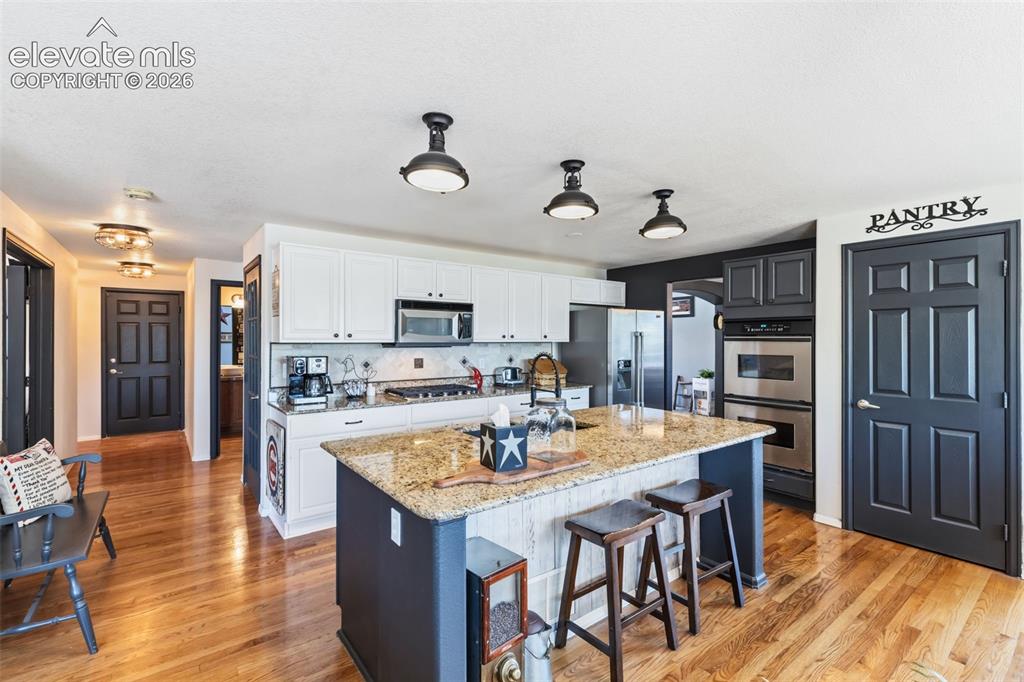 Image 12 of 47: Spacious Updated Kitchen with Large Center Island & Abundant Cabinetry
