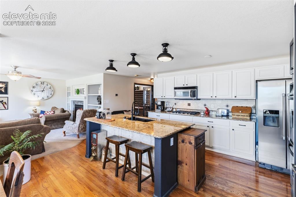 Image 13 of 47: Granite Countertops, Island Seating & Stainless Steel Appliances