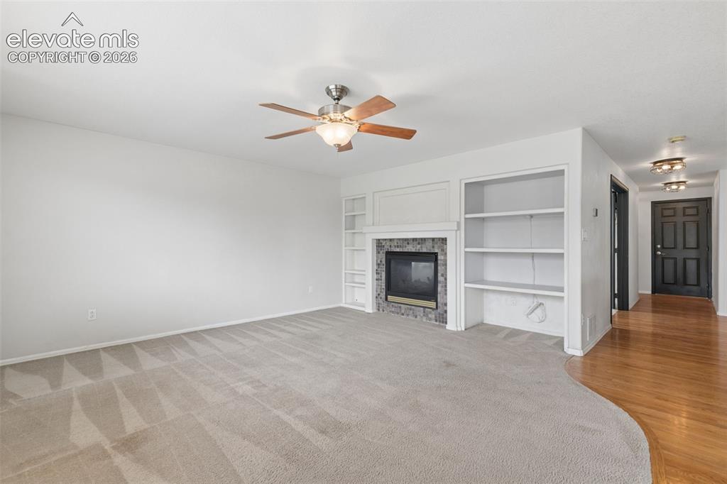 Image 20 of 47: Fireplace, Built-In Shelving & Plenty of Room to Gather