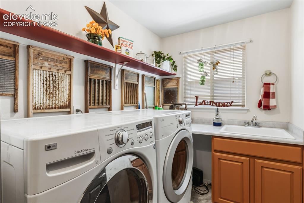 Image 25 of 47: Main Level Laundry with Utility Sink, Cabinetry & Storage Space