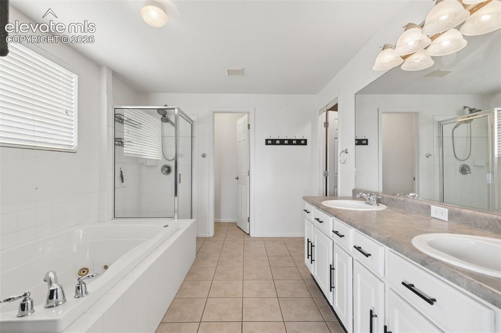 Image 29 of 47: Spacious 5-Piece Bath with Dual Vanities, Jetted Tub & Separate Shower