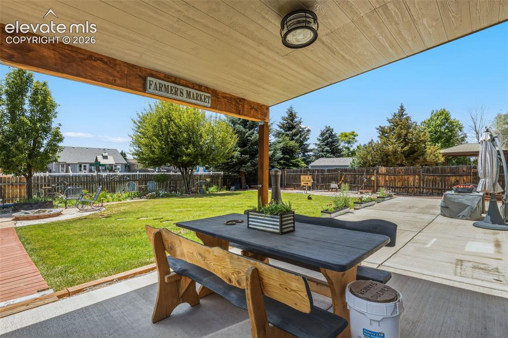 Image 37 of 47: Shaded Outdoor Living Space Overlooking the Backyard