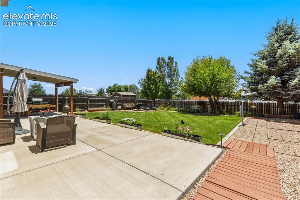 Image 38 of 47: Expansive Patio & Lawn with Plenty of Space to Gather and Play