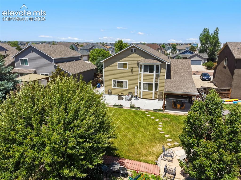 Image 42 of 47: Fenced Backyard & Established Woodmen Hills Setting