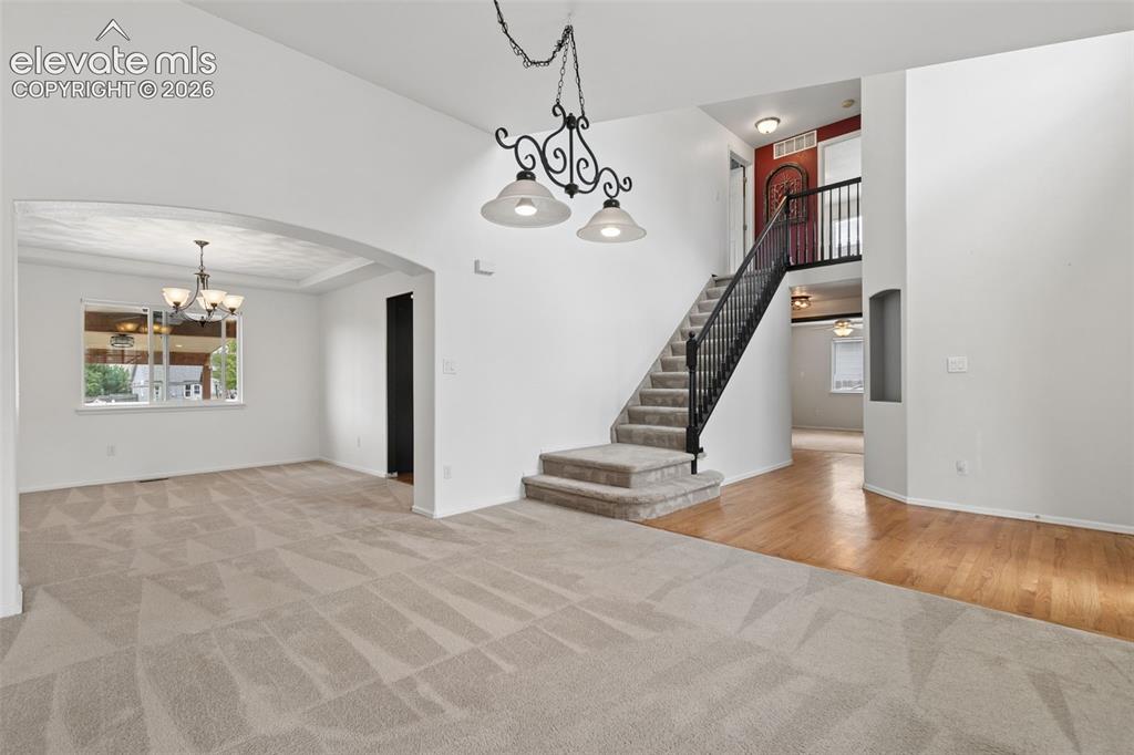 Image 9 of 47: Open Layout with Wood Flooring & Dramatic Staircase