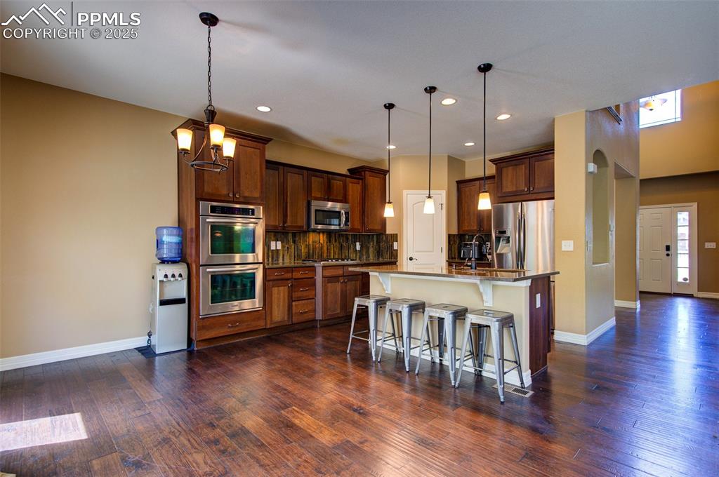 Image 14 of 50: Kitchen with stainless steel appliances, island and nice size pantry