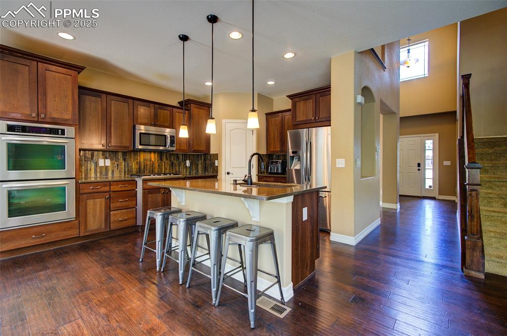 Image 16 of 50: Kitchen with view of front door to the right