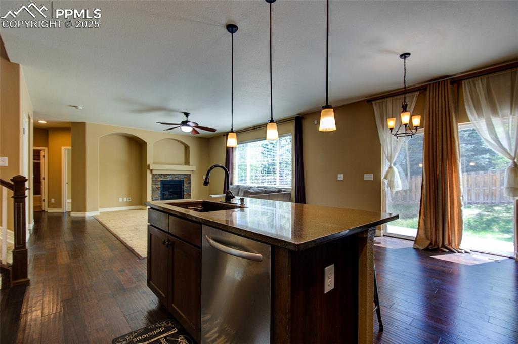Image 17 of 50: Kitchen island, dining area and access to sliding door to backyard