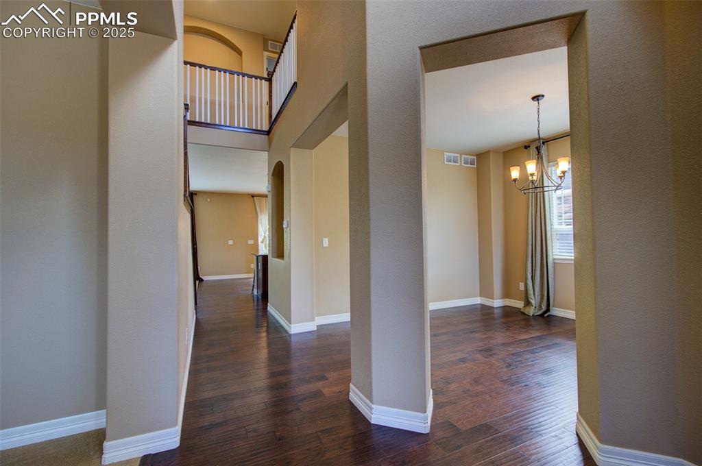 Image 2 of 50: Foyer with soaring ceilings, view from front door with formal dining room s