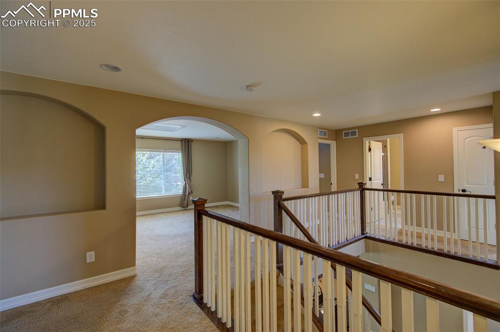 Image 23 of 50: 2nd floor landing looking into the loft/2nd living/family room space