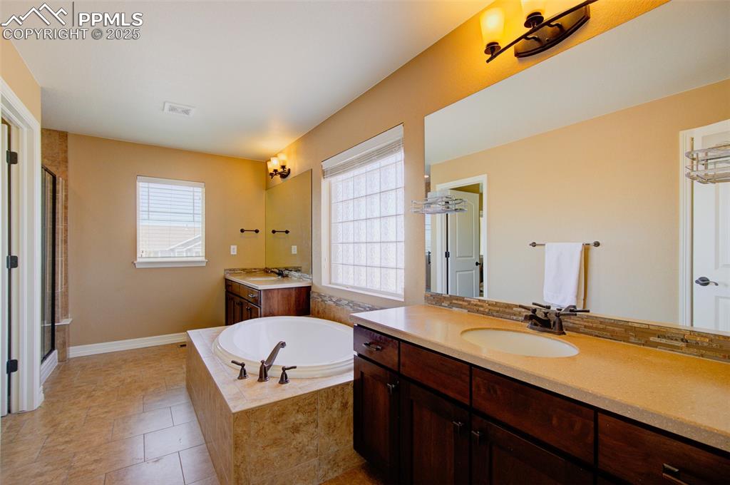 Image 33 of 50: Primary en-suite luxurious bathroom featuring 2 sinks/vanities, nice shower