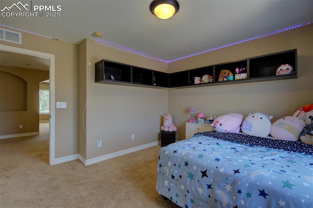 Image 37 of 50: 2nd bedroom with built in shelving