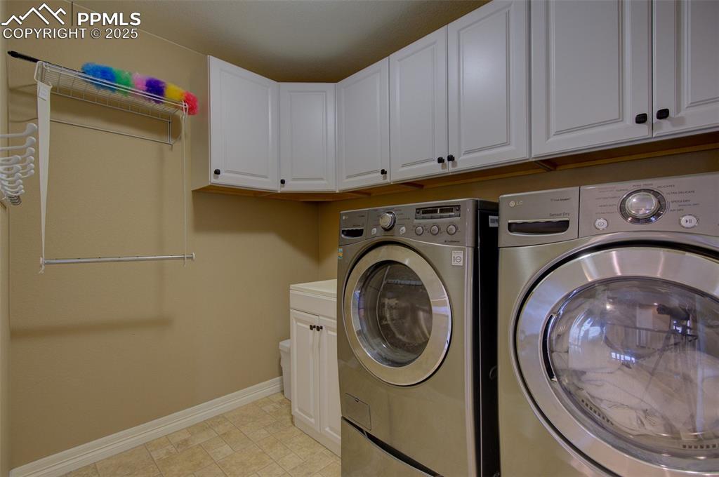 Image 43 of 50: 2nd floor laundry room, a lot of cabinet space, utility sink and space to h