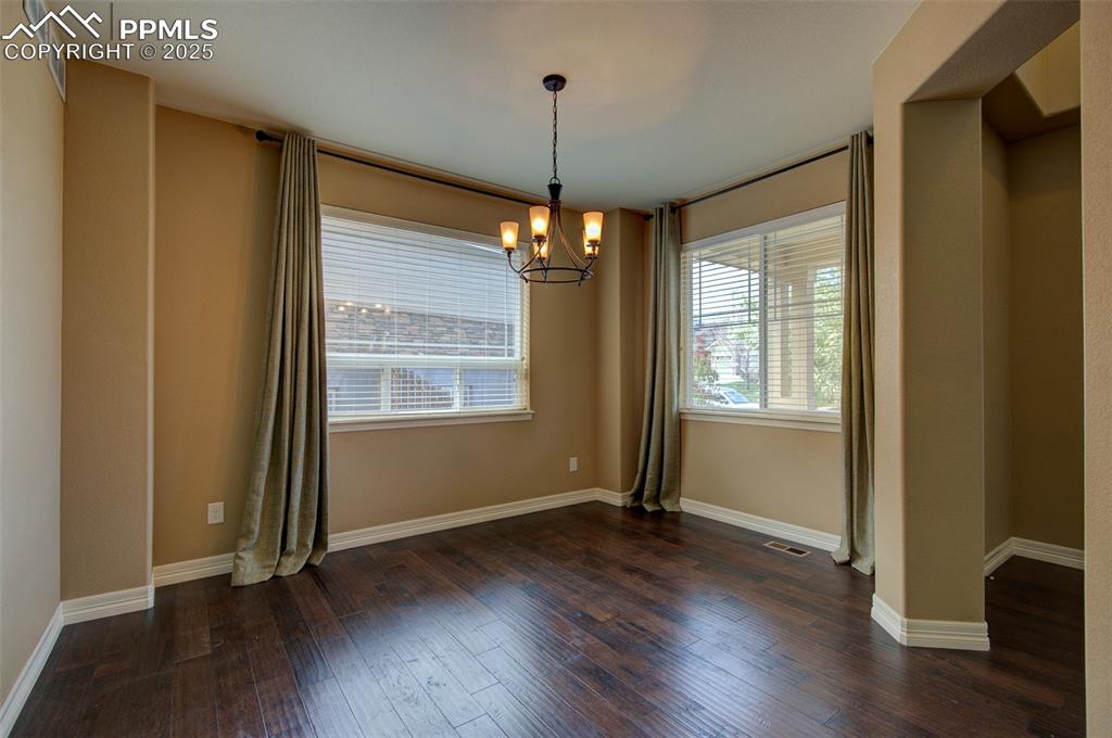 Image 5 of 50: Formal dining area featuring large windows allowing a ton of natural light