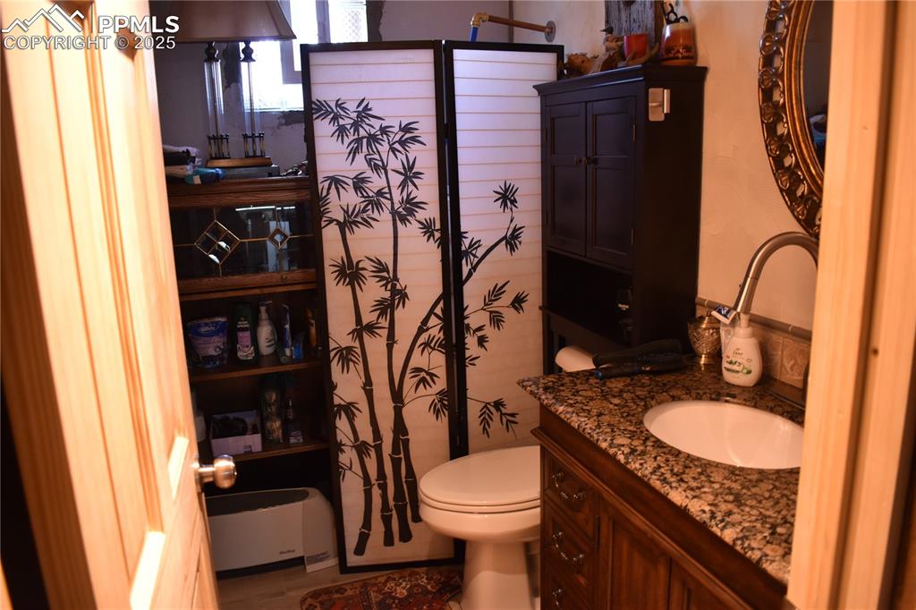 Image 16 of 23: Full bathroom with toilet and vanity