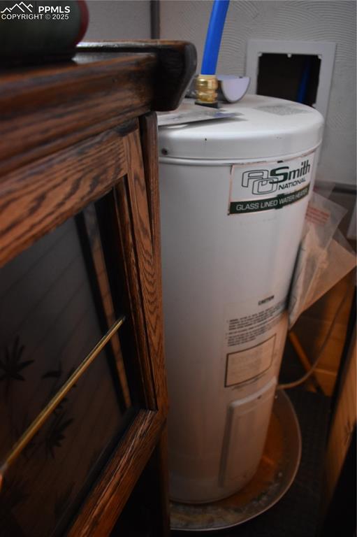 Image 17 of 23: Utility room with gas water heater