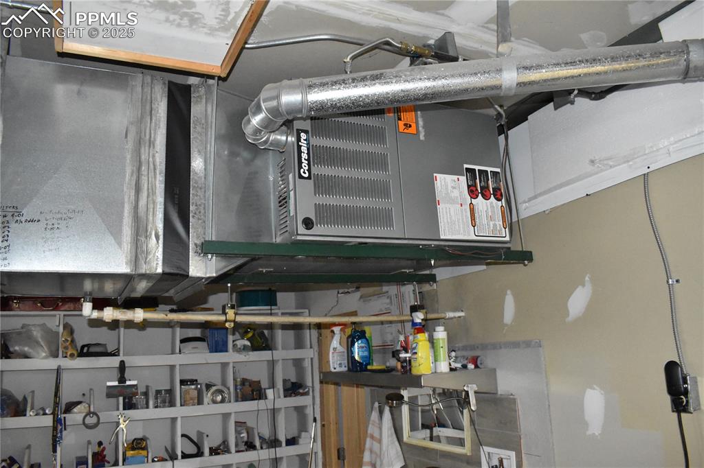 Image 21 of 23: Utility room with heating unit