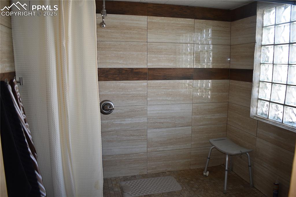 Image 22 of 23: Bathroom featuring a tile shower