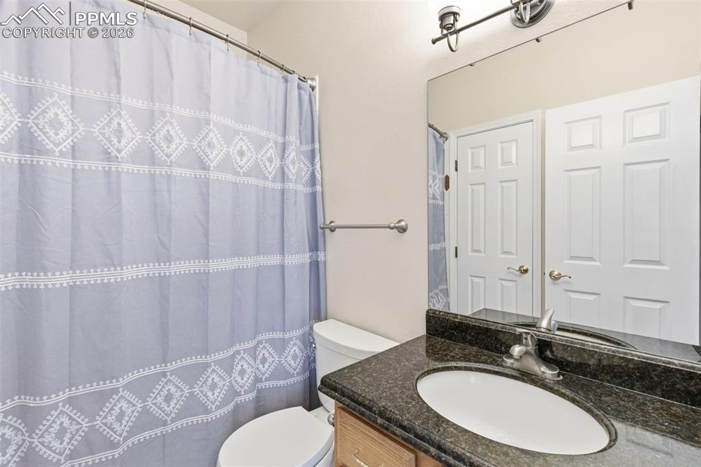 Image 30 of 43: Bathroom with vanity and a shower with shower curtain