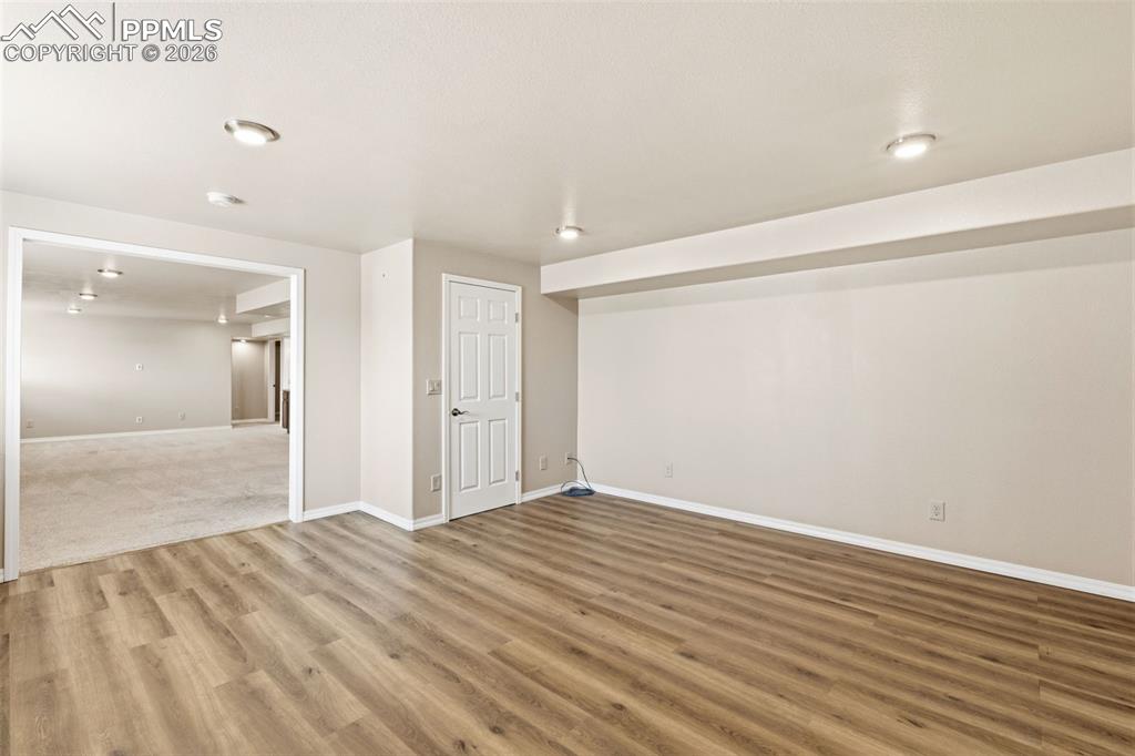 Image 34 of 43: Spare room featuring baseboards and light wood-style floors