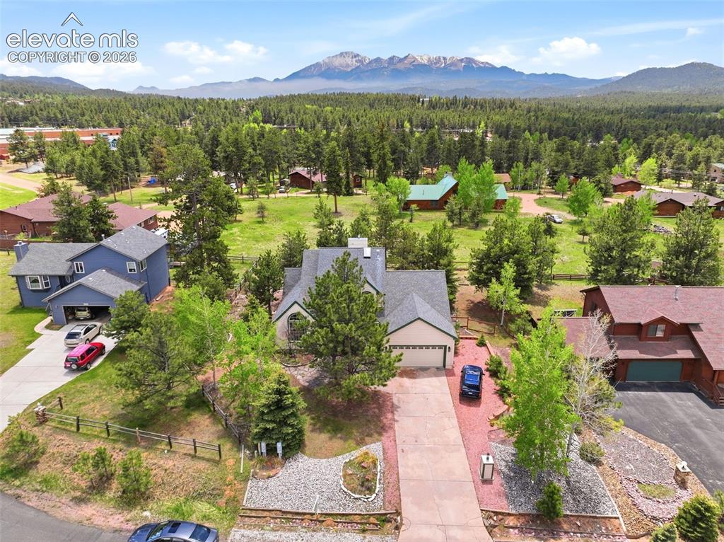 Image 2 of 41: Aerial perspective showcasing a property surrounded by mature trees, featur