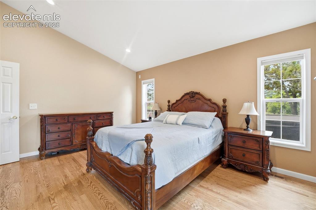 Image 27 of 41: Vaulted ceiling room featuring light wood-finish flooring, recessed lightin