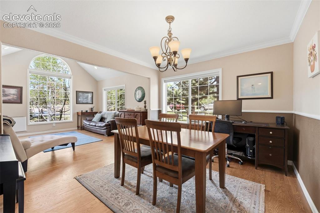 Image 3 of 41: Hardwood-finish flooring throughout, complemented by crown molding and chai