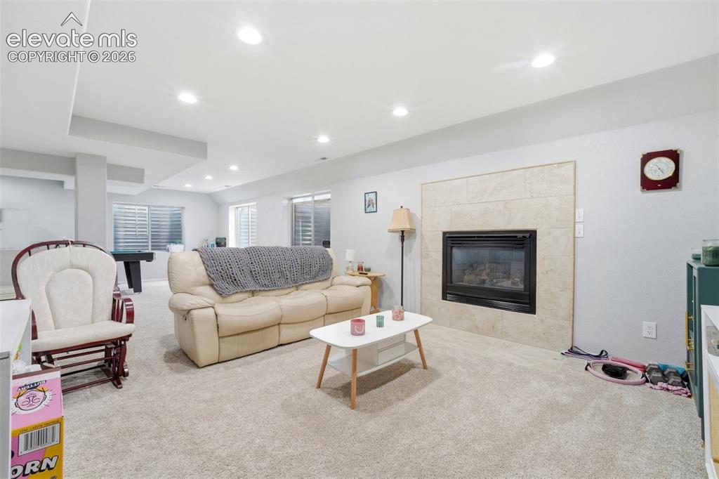 Image 30 of 41: Spacious lower-level living area featuring recessed lighting, light-toned c