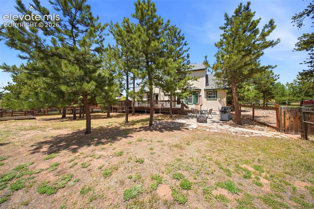 Image 37 of 41: Expansive outdoor space featuring a two-story residence with light-colored