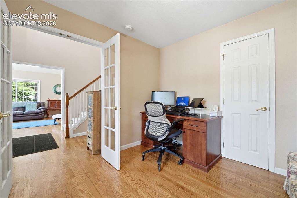 Image 7 of 41: Office space featuring light wood-finish flooring, neutral-toned walls, and