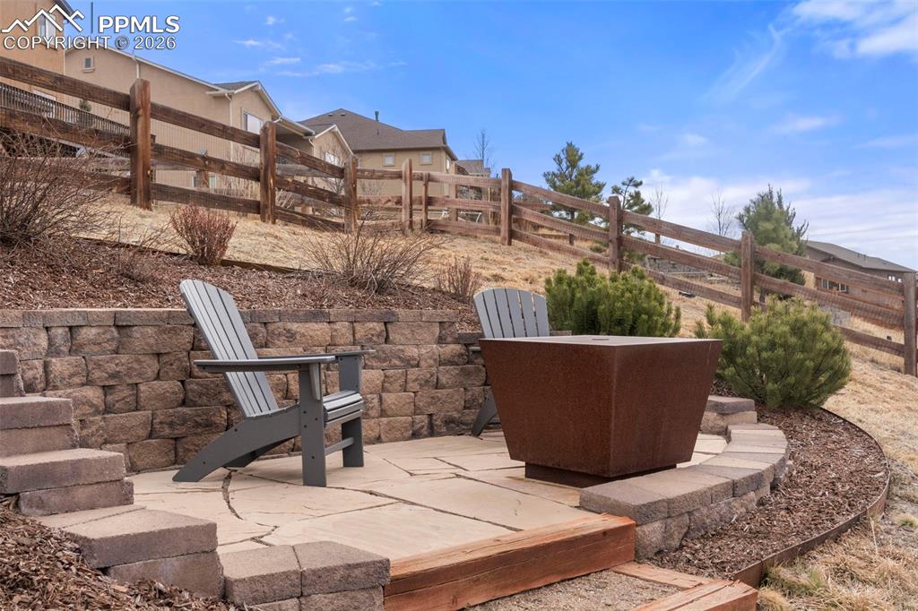 Image 38 of 49: sitting area in the backyard at the top of steps