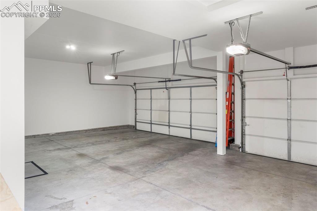 Image 42 of 49: finished garage with work bench. Even with the main level.