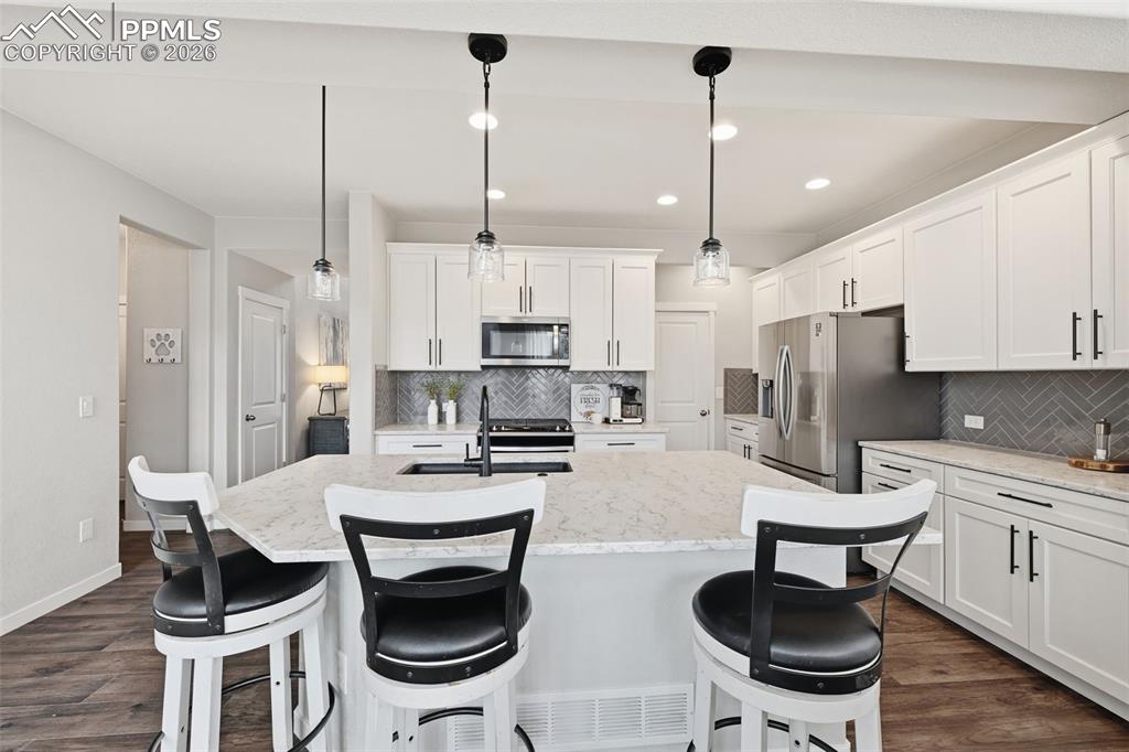 Image 10 of 41: Extra cabinets leading back to the walk-in pantry