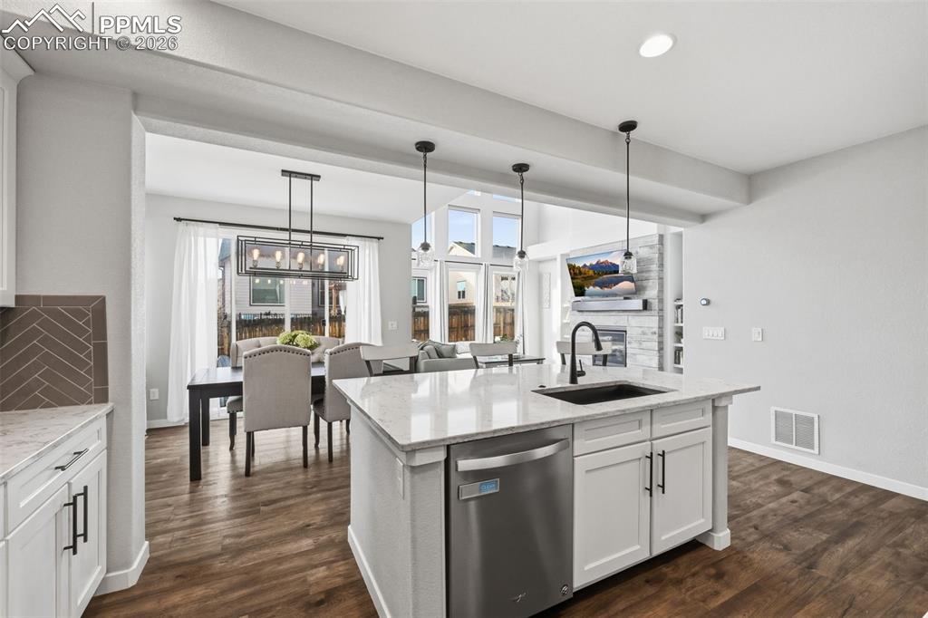 Image 12 of 41: Kitchen open to dining area and great room