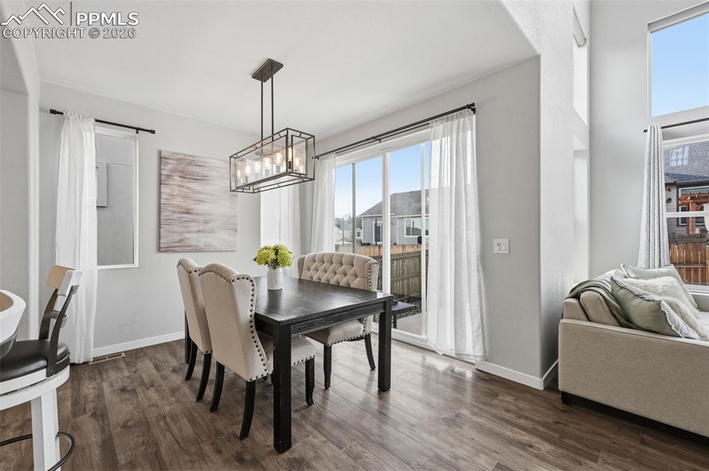 Image 13 of 41: Large dining room with sliding doors out to back patio