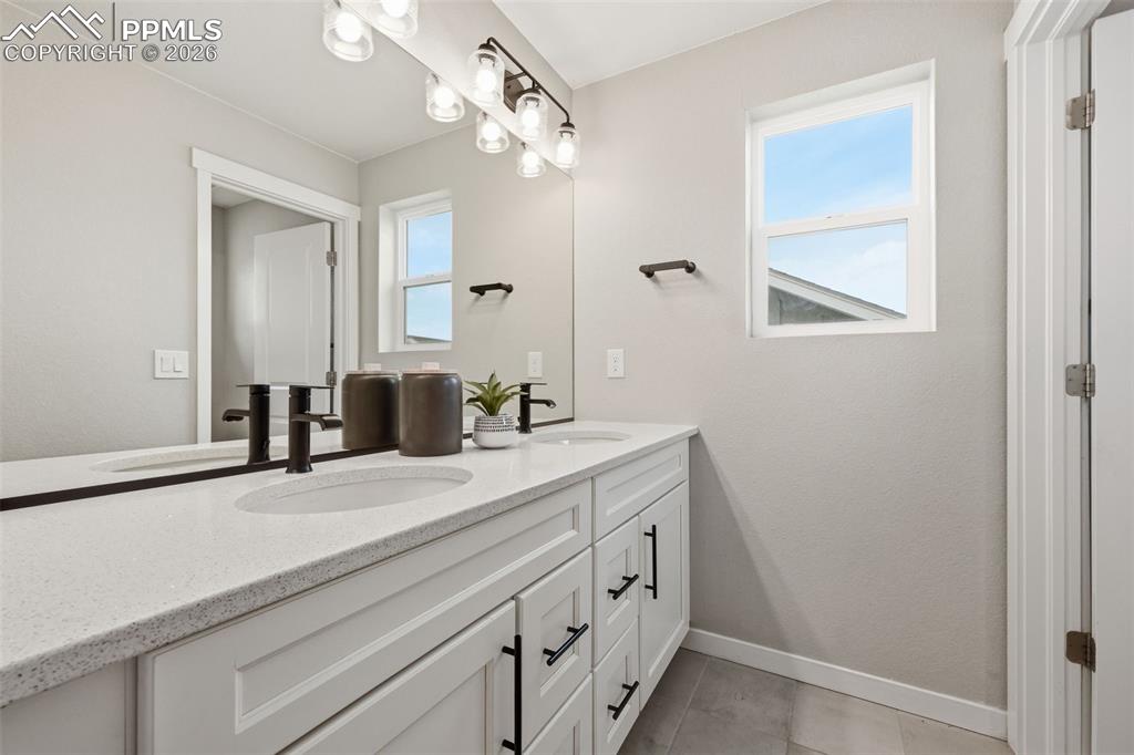 Image 28 of 41: Secondary full bathroom upstairs with double vanity and separate wet area