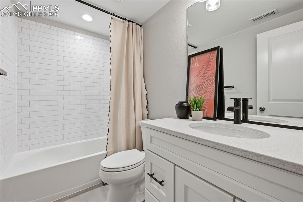 Image 33 of 41: Basement full bathroom with upgraded quartz countertops