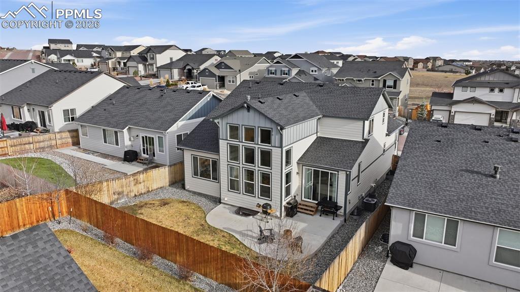 Image 36 of 41: Fully fenced in back yard with sod and rocks