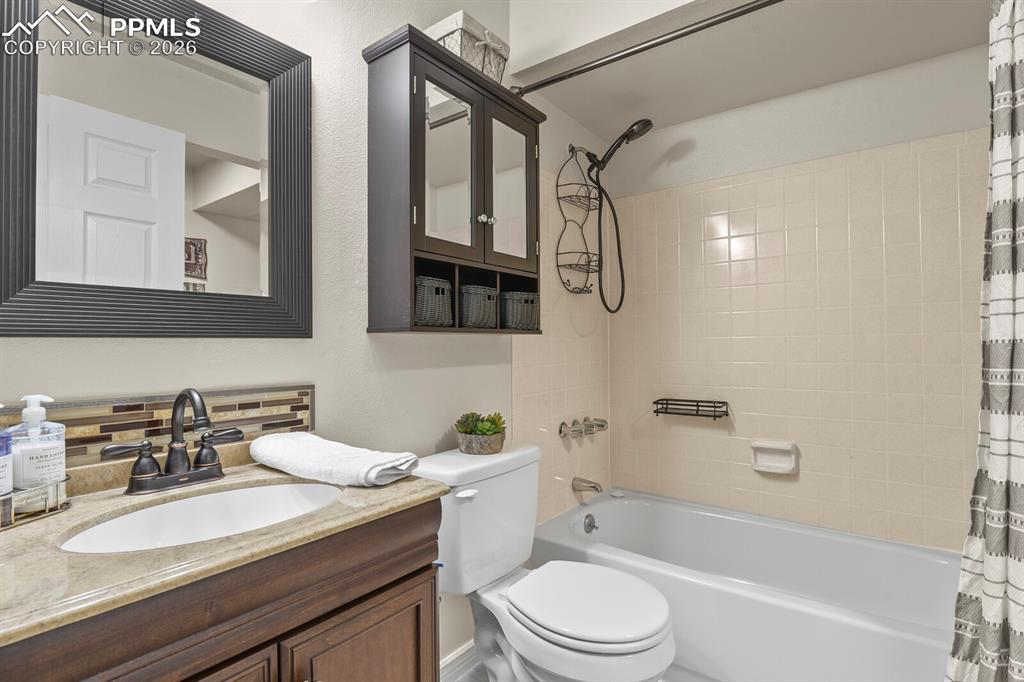 Image 27 of 32: Bathroom with vanity and shower / bath combination with curtain