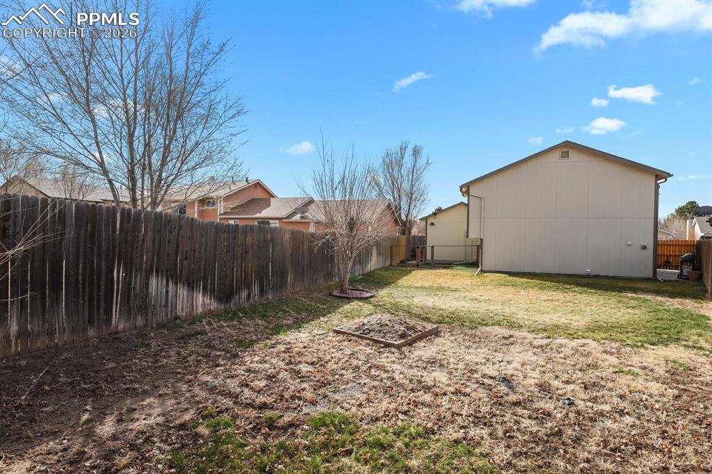 Image 32 of 32: View of fenced backyard