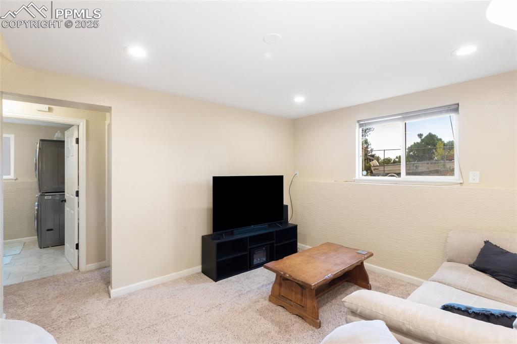 Image 10 of 35: Carpeted living room with recessed lighting