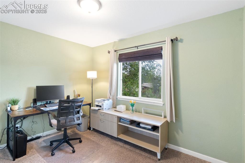 Image 17 of 35: Office space with light carpet and baseboards