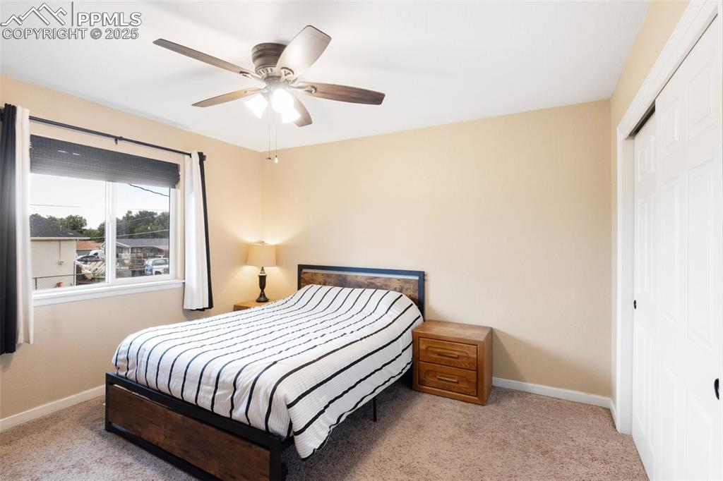 Image 22 of 35: Carpeted bedroom featuring a closet and ceiling fan