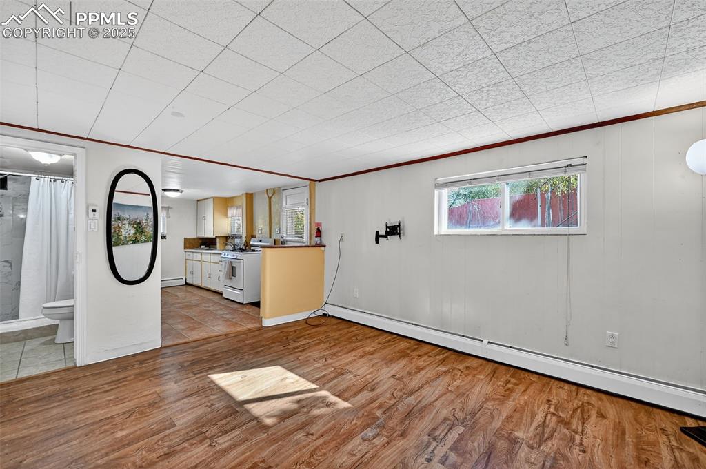 Image 29 of 46: ADU Living room looking towards kitchen and entry door and bathroom in Base